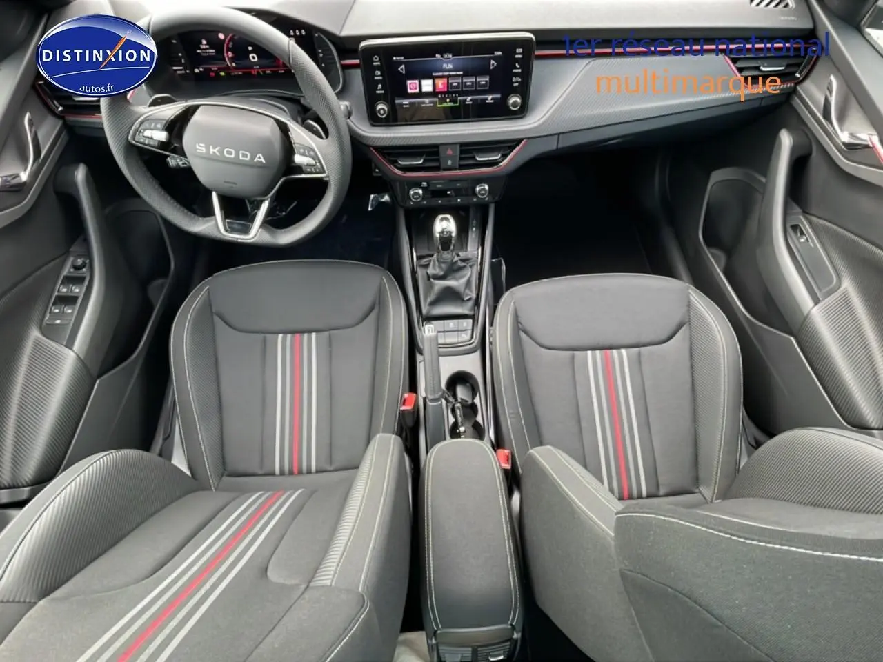 Vue intérieure avant du Skoda Kamiq Monte Carlo avec sièges sport noirs à bandes rouges et volant multifonction cuir.
