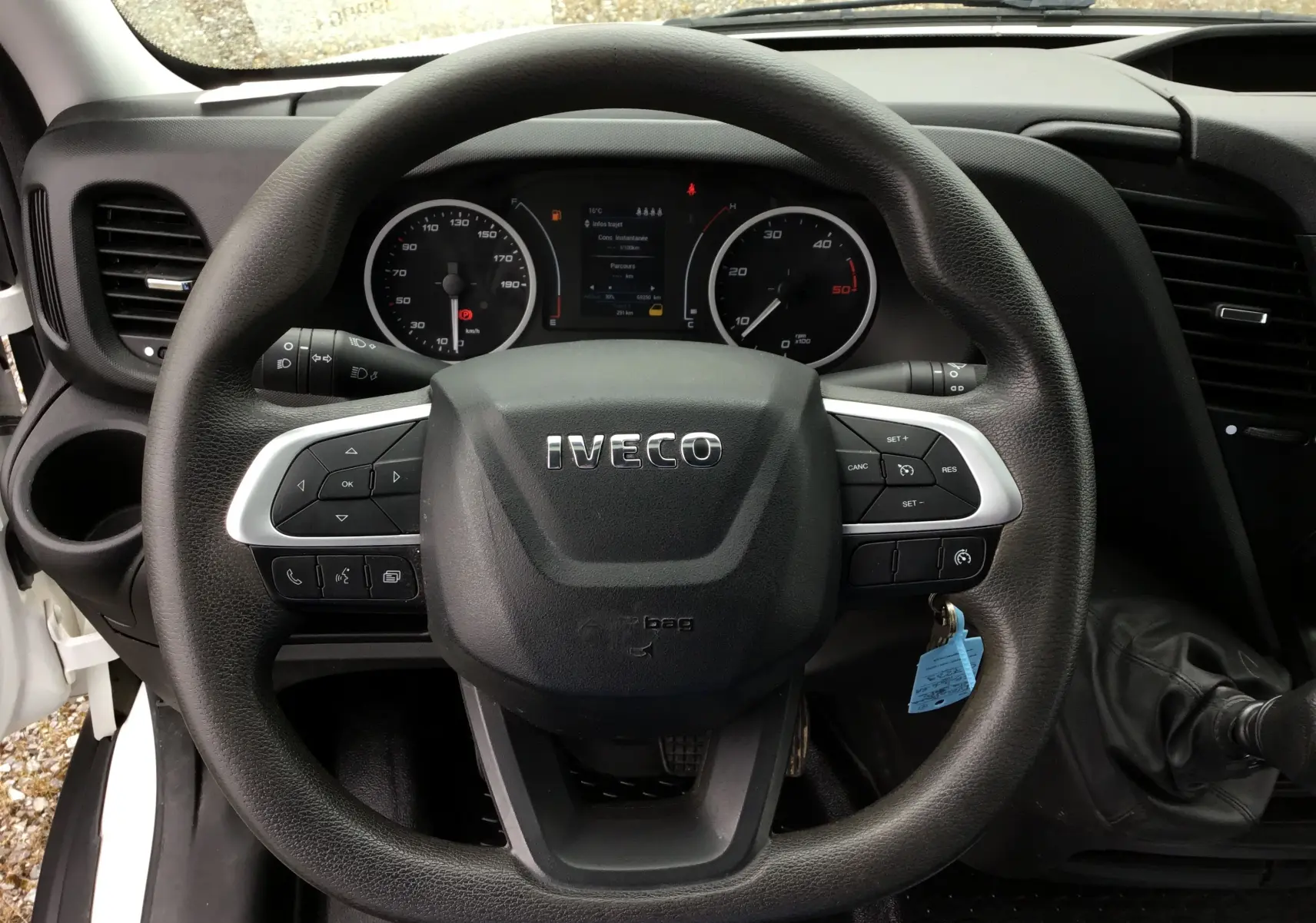 Vue rapprochée du volant Iveco avec commandes intégrées et tableau de bord digital du Daily Chassis Double Cabine blanc.