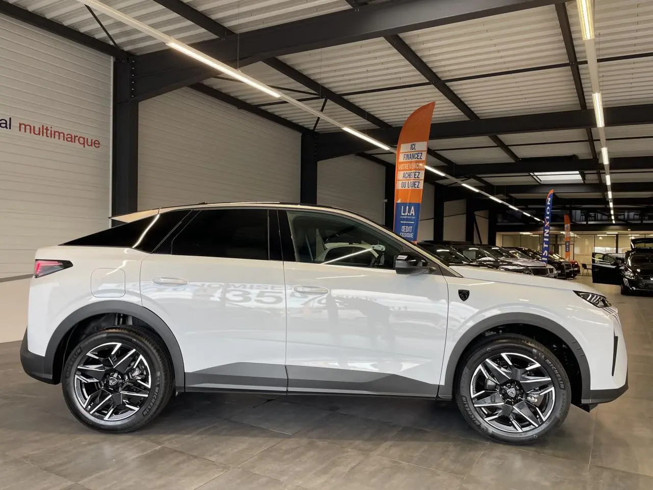 Peugeot 3008 Hybrid blanc okenite vue de profil côté gauche en intérieur avec jantes alliage 19 pouces.