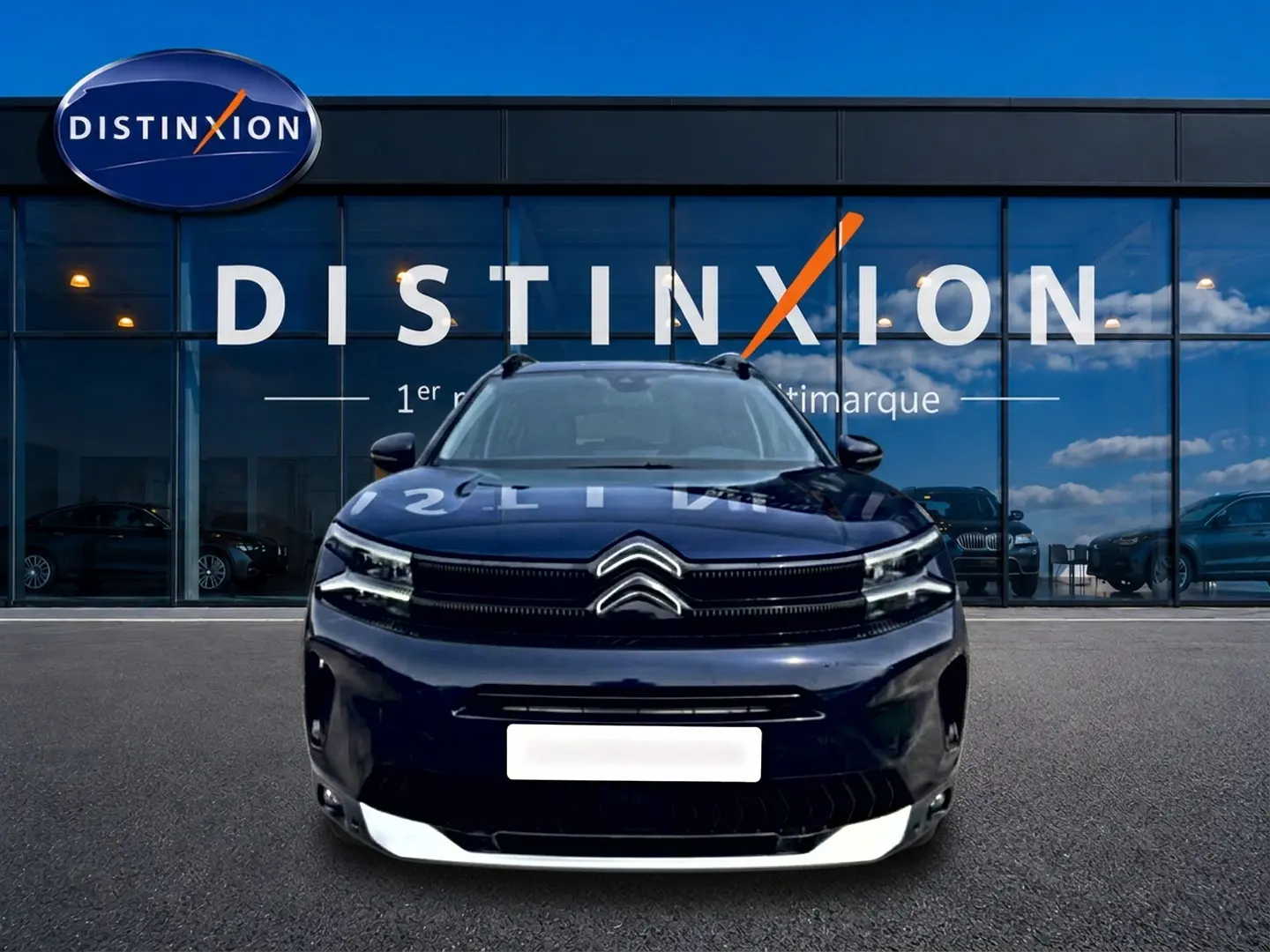 Vue frontale d'un Citroën C5 Aircross bleu eclipse avec calandre noire et barres de toit visibles.