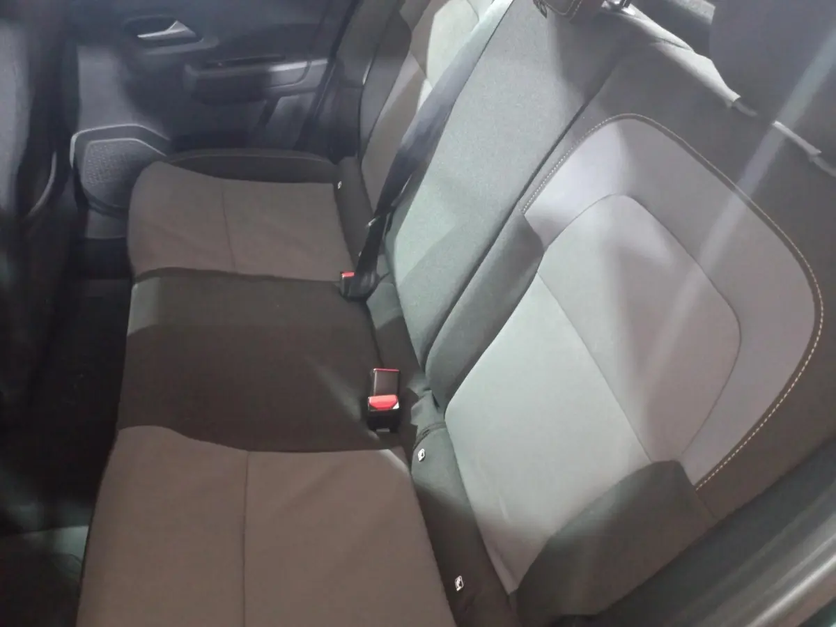 Vue intérieure de la banquette arrière grise et noire de la Dacia Sandero Extreme+ TCe 110, avec ceintures de sécurité visibles.
