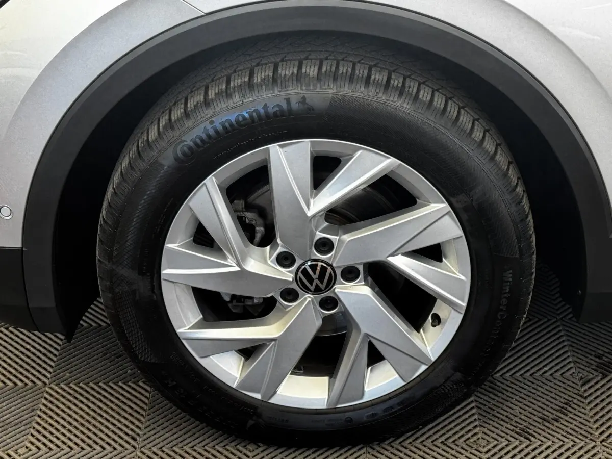 Gros plan sur la roue avant droite gris clair du Volkswagen Tiguan 1.5 TSI avec jante alliage et pneu Continental hiver.