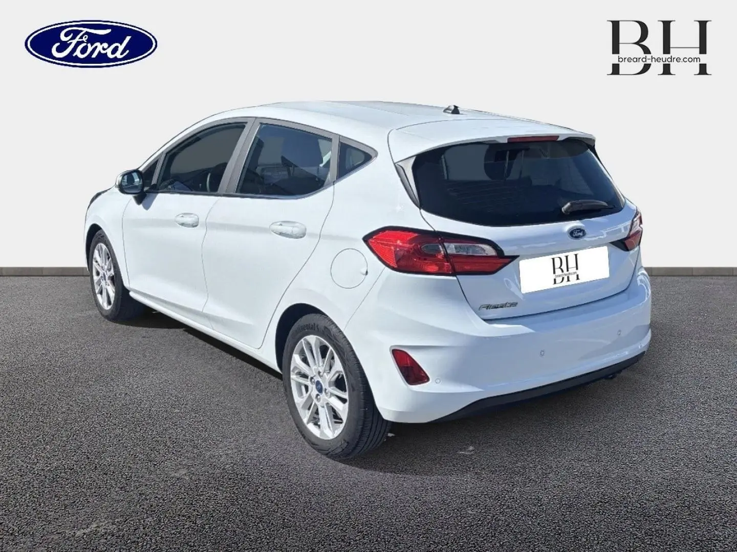 Vue 3/4 arrière droite d'une Ford Fiesta blanc glacier avec jantes alu et feux arrière LED distinctifs.