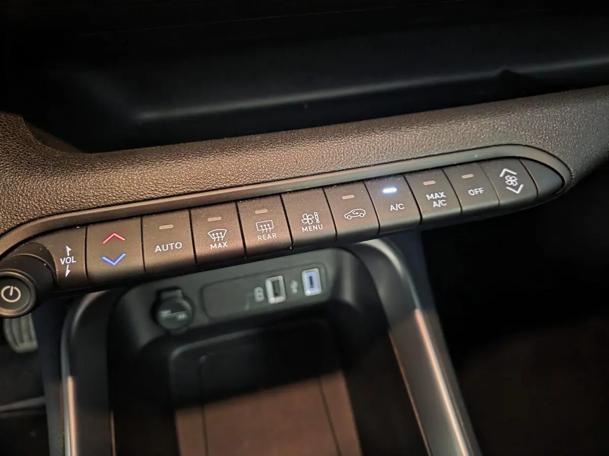 Détail de la console centrale du Jeep Avenger 2024, montrant les commandes de climatisation et prises USB.