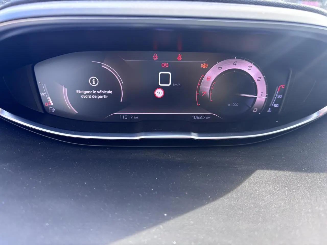 Tableau de bord numérique du Peugeot 5008 blanc 2022, affichant compteur et message d'arrêt avant départ.