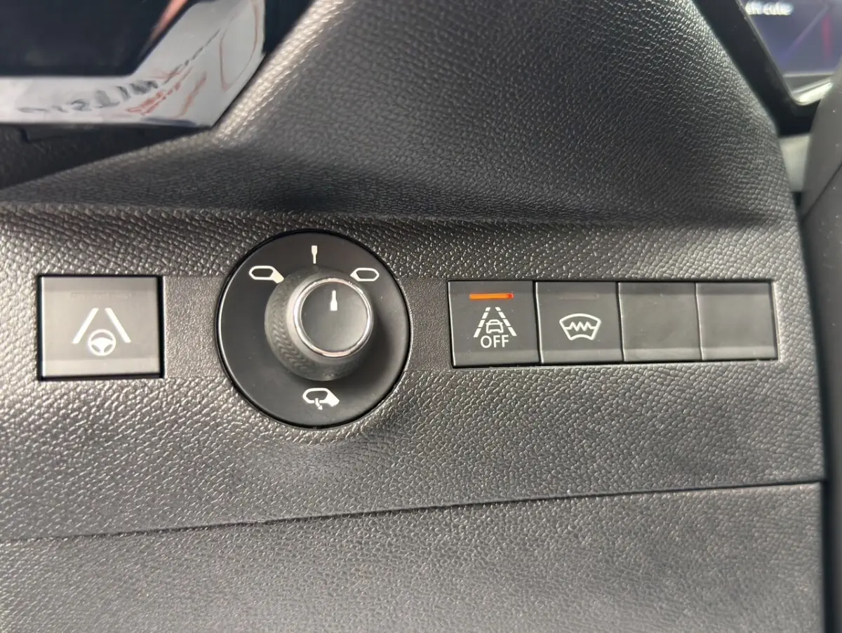 Gros plan sur les commandes de sécurité et réglages des rétroviseurs du DS7 Crossback gris clair, côté conducteur.