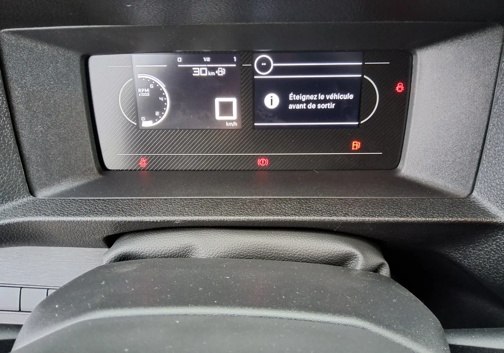 Vue rapprochée du tableau de bord numérique du Peugeot Expert Fourgon 2025, affichant un message d'alerte et compte-tours.