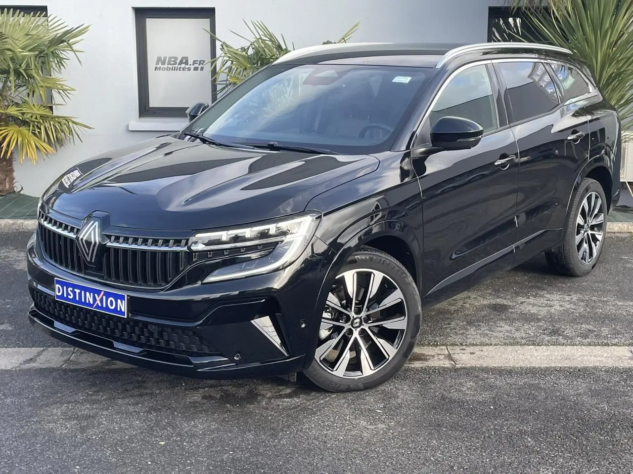 Vue 3/4 avant droite du Renault Espace noir étoilé 2024 avec jantes alliage et calandre distinctive.