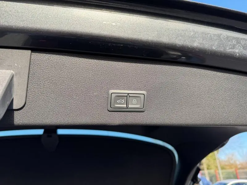 Boutons d'ouverture et de verrouillage du coffre sur la partie intérieure du hayon d'une Audi E-Tron Sportback gris foncé métal.