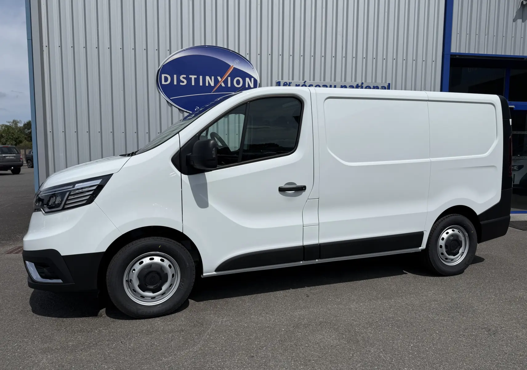 Vue de profil côté gauche d’un Renault Trafic Fourgon blanc 2025 avec jantes acier et rétroviseurs noirs.