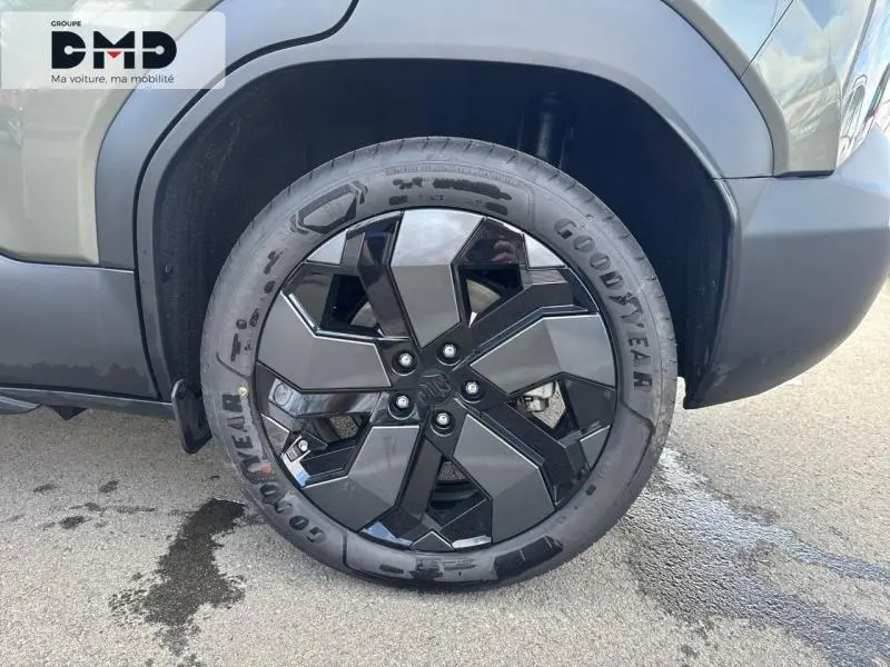 Gros plan sur la roue avant droite du Suzuki Vitara 2026 vert Land Breeze avec jante alu noire et grise au design géométrique.