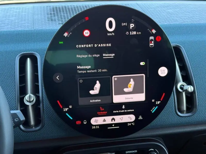 Tableau de bord circulaire de MINI Countryman 2024, affichage digital du confort d'assise et massage, intérieur noir.