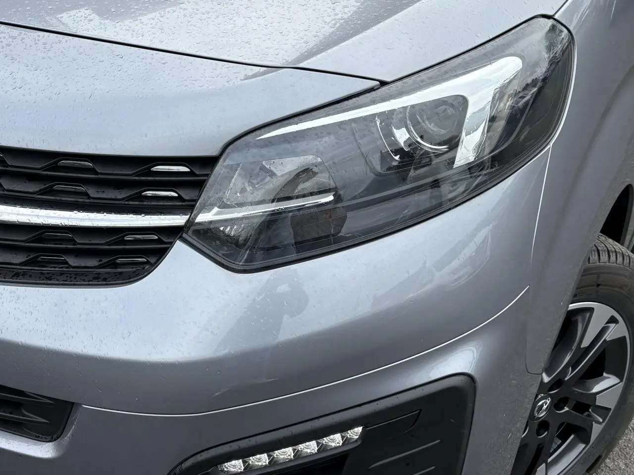 Gros plan sur l'avant droit gris Artense de l'Opel Zafira Life XL 2024 avec phare LED et jante alliage noire.
