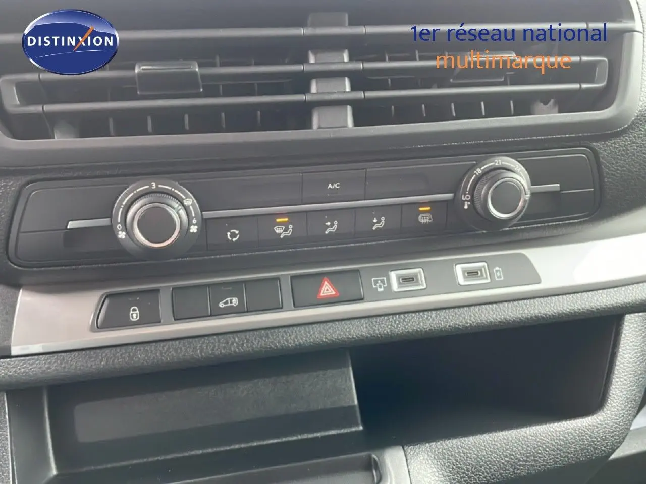 Vue rapprochée du tableau de bord du Citroën Jumpy gris, montrant les commandes de climatisation et les ports USB.