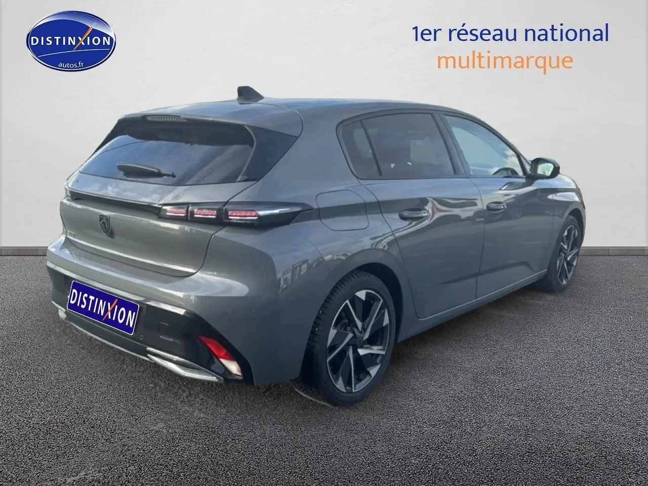 Vue 3/4 arrière droite d'une Peugeot 308 gris sélénite avec jantes alliage et feux arrière LED distinctifs.