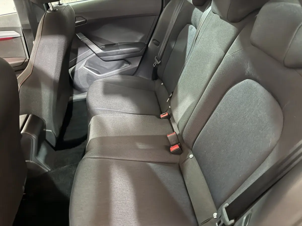 Vue intérieure côté droit de la banquette arrière noire du SEAT Ibiza 1.0 TSI 110 FR 2024 avec ceintures visibles.