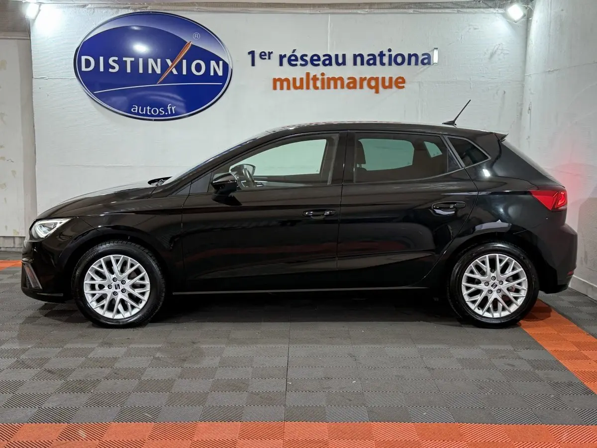 Profil droit d'une SEAT Ibiza 1.0 TSI 110 FR noire, avec jantes alliage et feux arrière LED visibles.