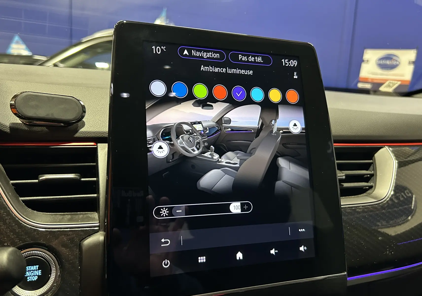Écran tactile central montrant l'ambiance lumineuse intérieure avec tableau de bord et volant Renault Arkana noir.