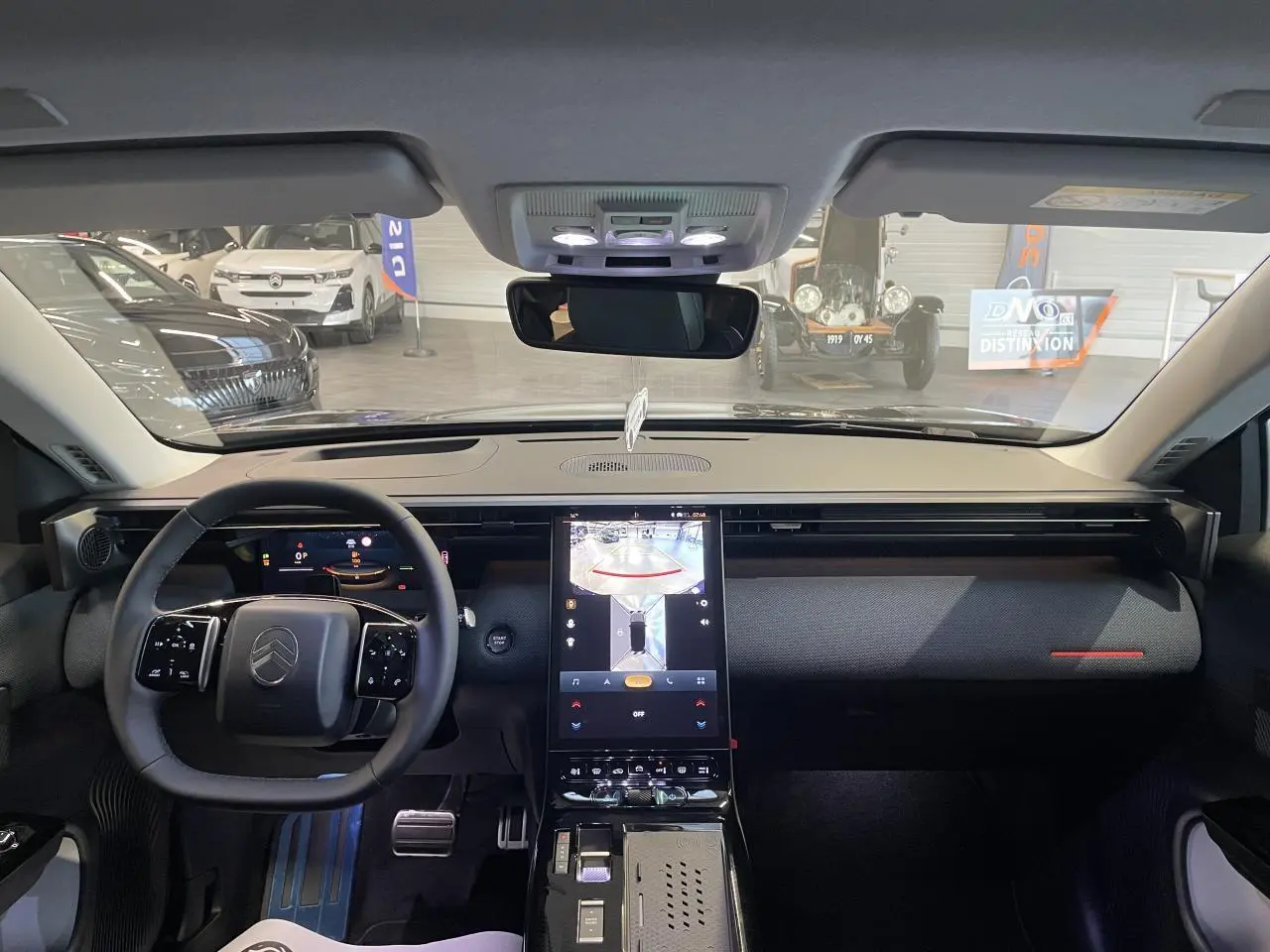 Vue intérieure avant du Citroën C5 Aircross bleu Azul, tableau de bord moderne avec écran tactile vertical et volant multifonctions.