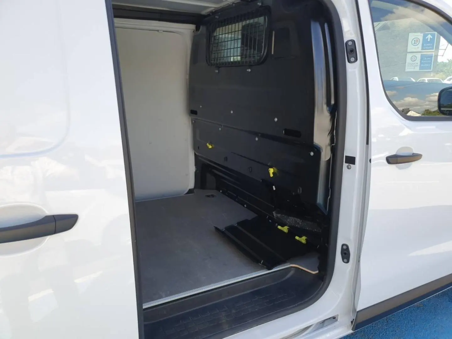 Vue latérale droite du Toyota Proace Fourgon blanc Glacier avec porte coulissante ouverte sur l'espace de chargement vide.