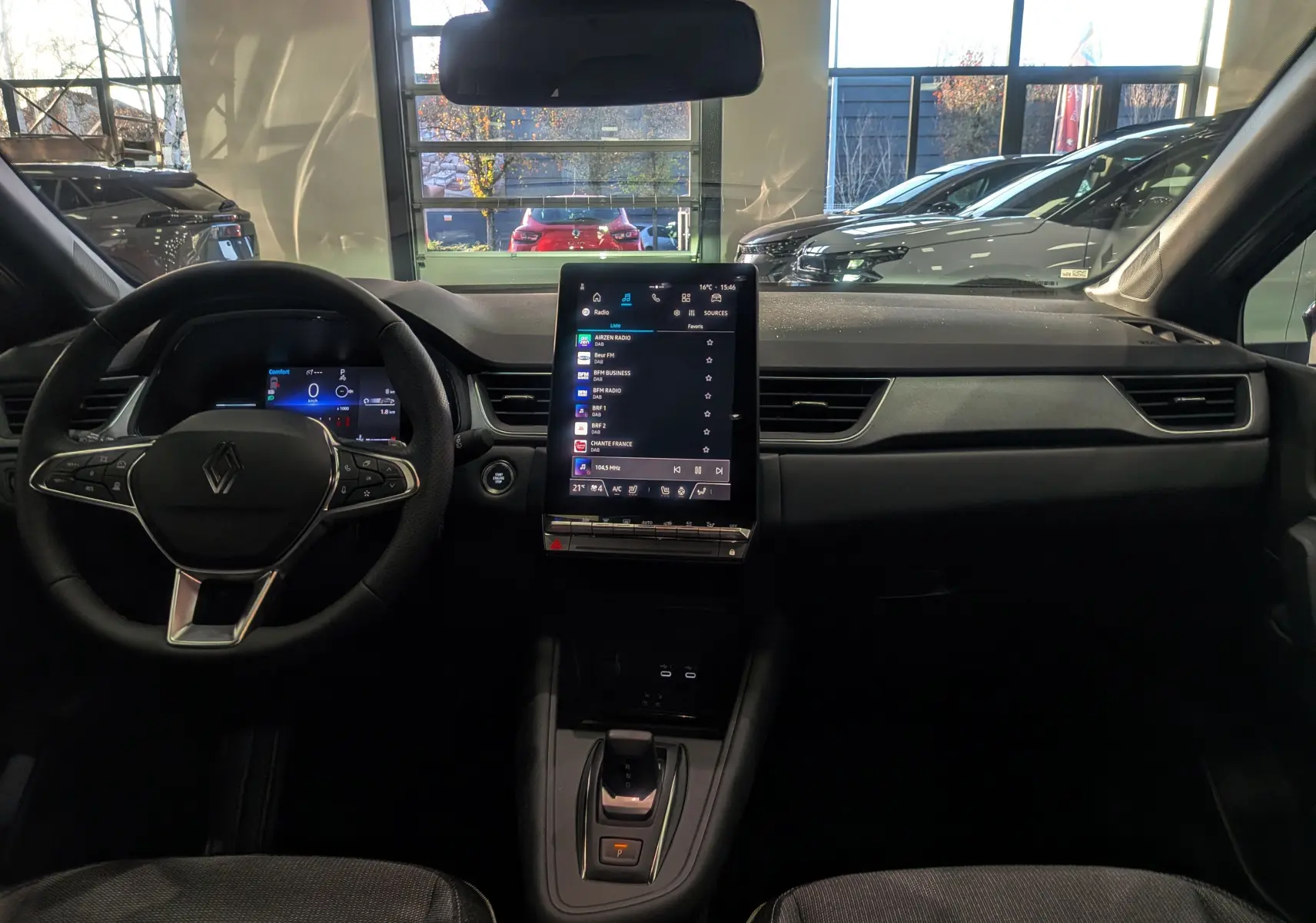 Vue intérieure avant du Renault Captur 2025 avec tableau de bord numérique et écran tactile vertical central.