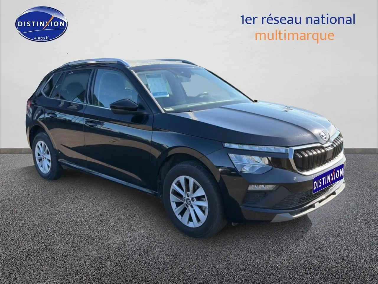 Vue 3/4 avant droite d’un Skoda Kamiq noir avec calandre chromée et jantes alu sur fond neutre.