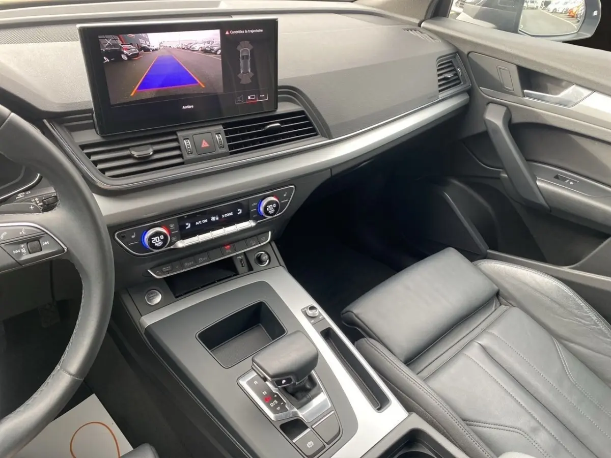 Vue intérieure de l'Audi Q5 35 TDI 2022, montrant la console centrale avec levier de vitesse et écran tactile de recul.