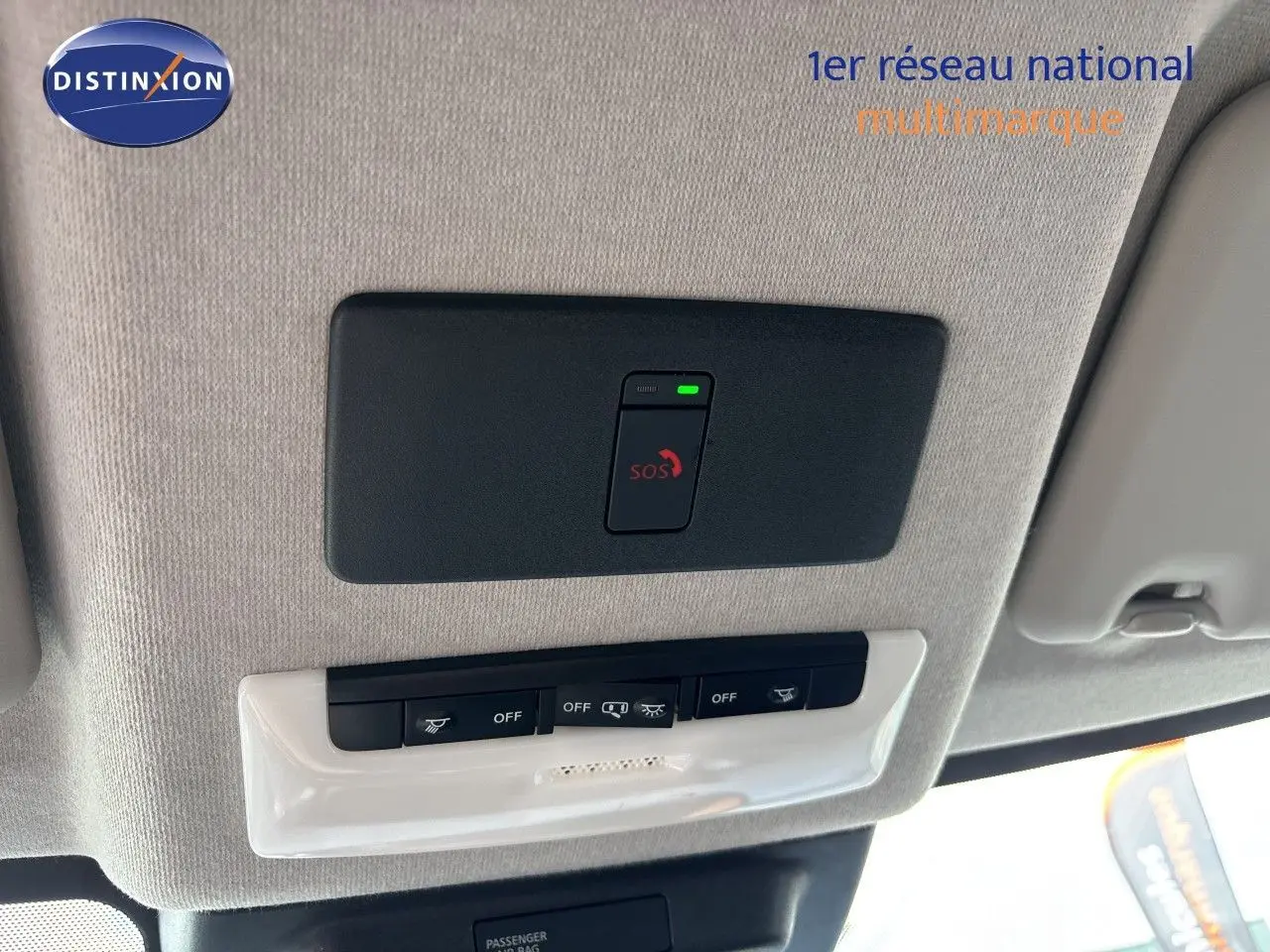 Vue intérieure du toit avec panneau de commandes et bouton SOS du Nissan Juke Hybrid gris Squale Metal 2024.
