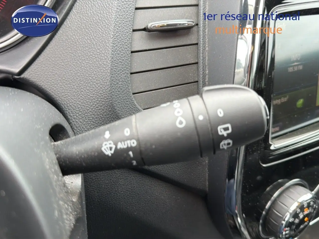 Gros plan sur la commande d’essuie-glace à gauche du tableau de bord d’un Renault Captur gris Cassiopée avec toit noir.