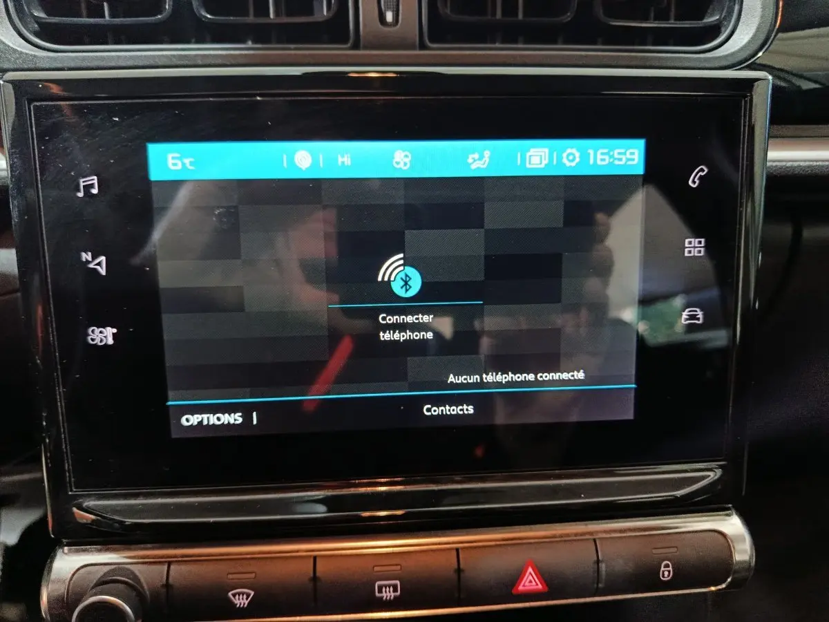 Écran tactile central de la Citroën C3 BlueHDi 100 2024 affichant la connexion Bluetooth, entouré de commandes noires.