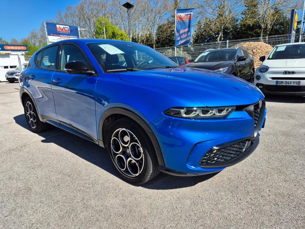 Alfa Romeo Tonale bleu en 3/4 avant droit, avec jantes alliage 18 pouces et rétroviseurs noirs brillants.