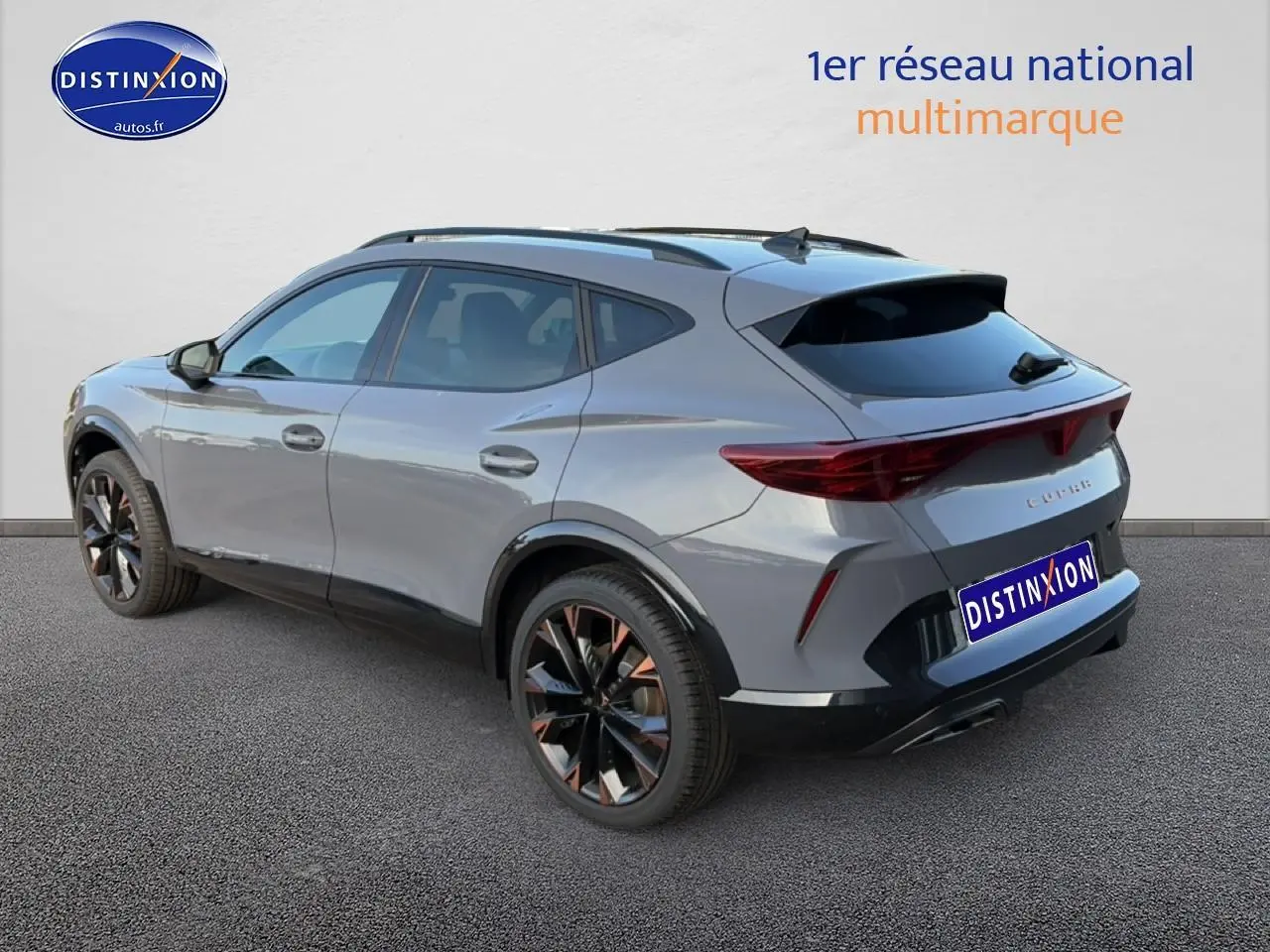 Vue 3/4 arrière droite du CUPRA Formentor gris graphene avec jantes noires et détails cuivrés, vitres arrière surteintées.