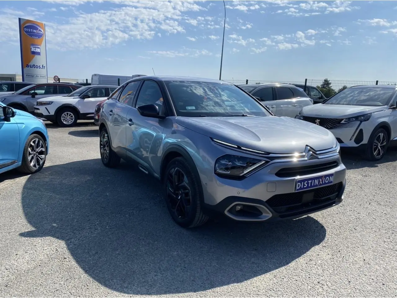Citroën C4 gris foncé vue 3/4 avant droit, avec jantes noires et calandre distinctive Shine Pack 2021.