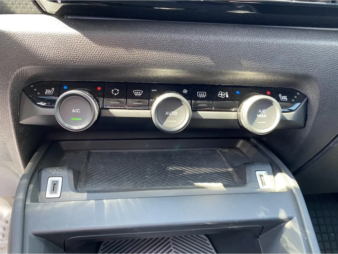 Vue rapprochée du tableau de bord du Citroën C4 2021 gris foncé, montrant les commandes de climatisation automatique.