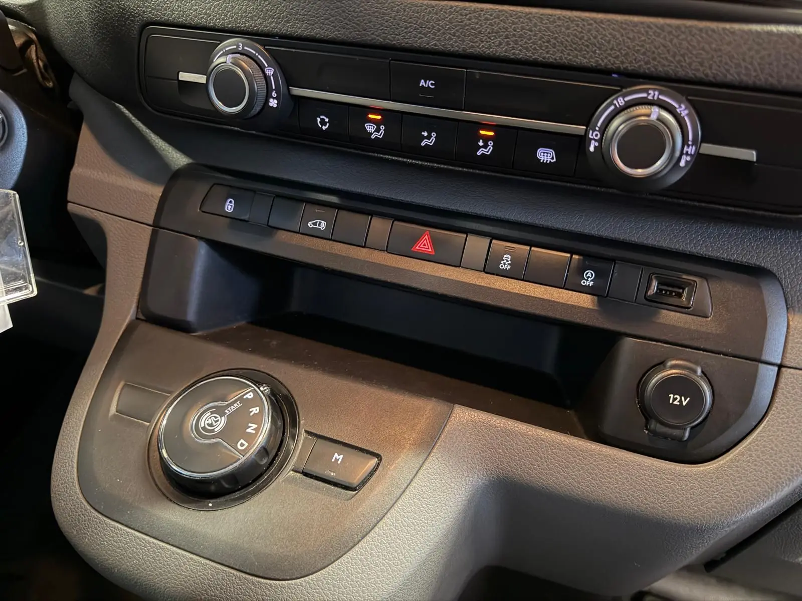 Vue rapprochée de la console centrale noire du Citroën Jumpy 2.0 BlueHDi 180 EAT avec molette de boîte auto et commandes climatisation.