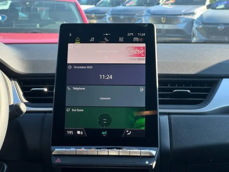 Tablette centrale tactile du Renault Captur 2025 affichant radio, téléphone et climatisation, vue intérieure frontale.