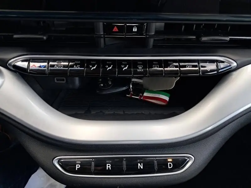 Vue rapprochée de la console centrale de la Fiat 500C 118 cv icone électrique 2021 avec commandes climatisation et levier de vitesses automatique.