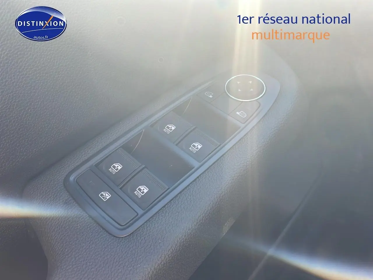 Gros plan sur les commandes des vitres électriques côté gauche de la Renault Clio V bleu iron, intérieur noir.