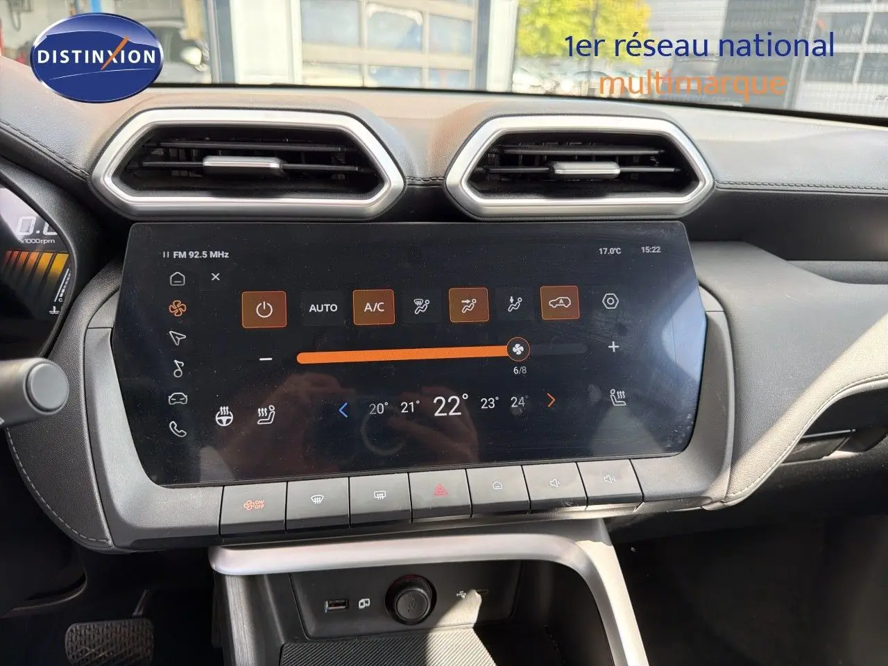 Vue rapprochée du tableau de bord du MG ZS 2025, écran tactile central avec commandes climatisation affichées.