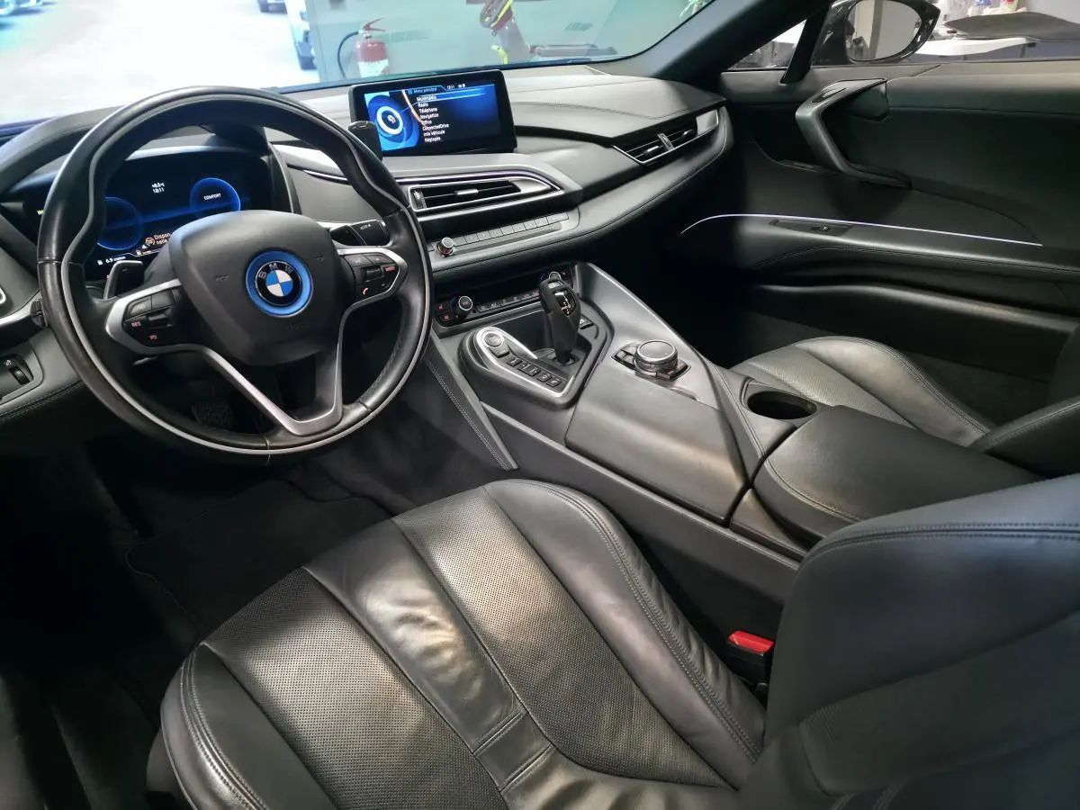 Intérieur noir de la BMW i8 Coupé Pure Impulse 2015, vue côté conducteur avec tableau de bord numérique et console centrale moderne.