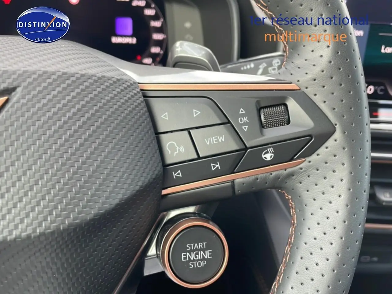 Gros plan sur le volant cuir perforé du Cupra Formentor gris magnétique, avec commandes multifonctions et bouton start/stop visible.