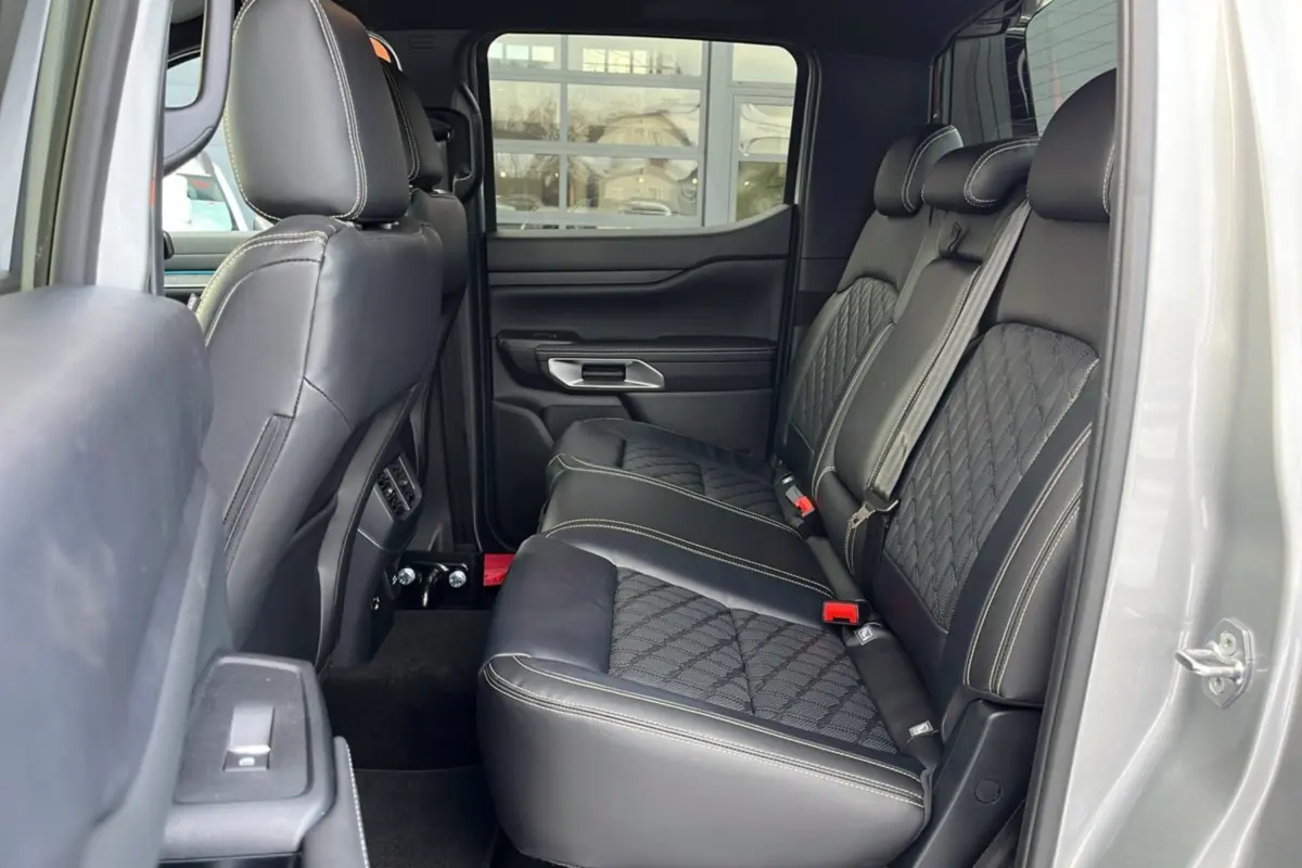 Vue latérale intérieure des sièges arrière en cuir noir avec surpiqûres blanches du Ford Ranger gris iconic 2026.