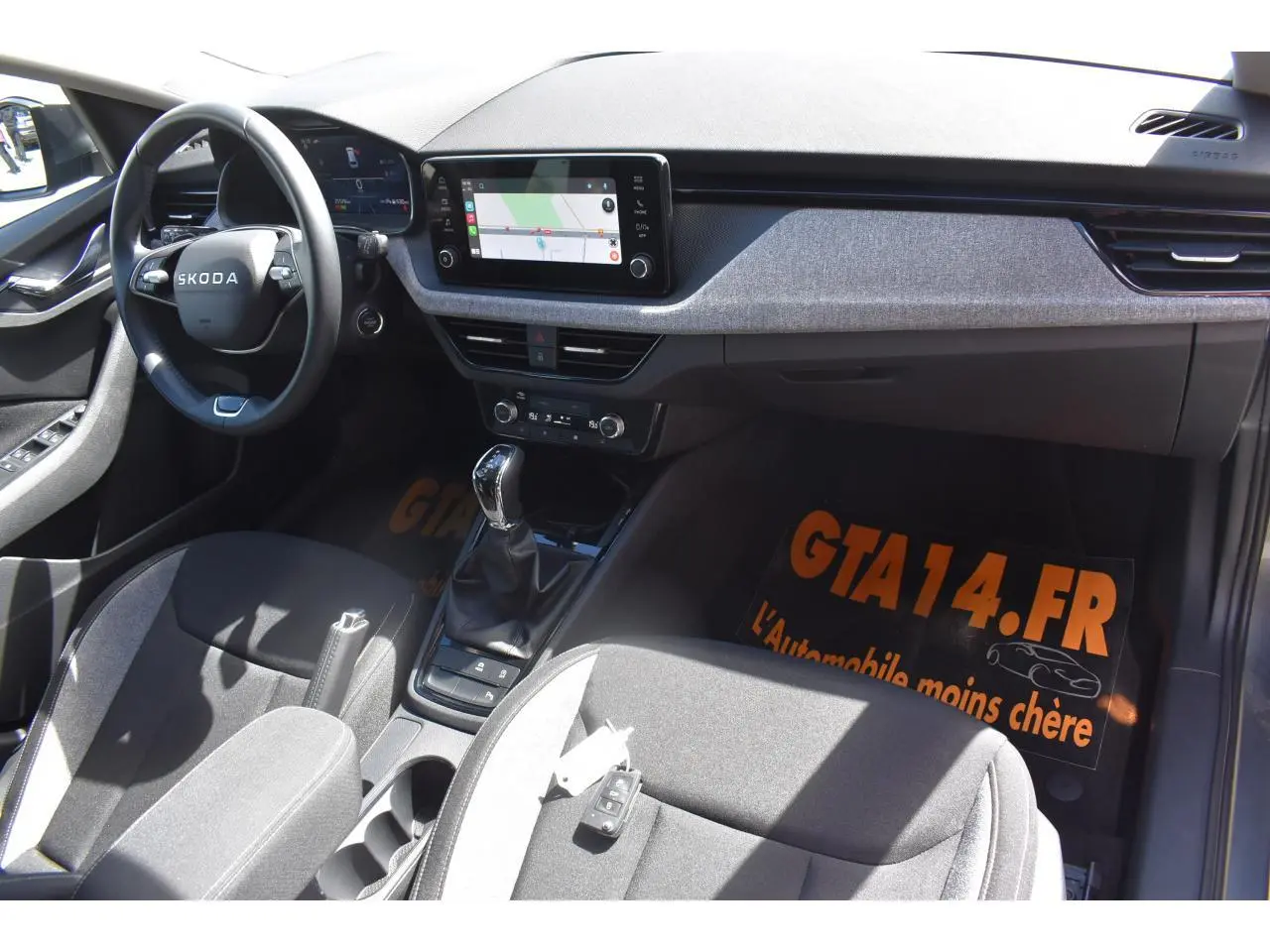 Vue intérieure avant droite du Skoda Scala gris graphite, avec tableau de bord moderne et écran tactile central.
