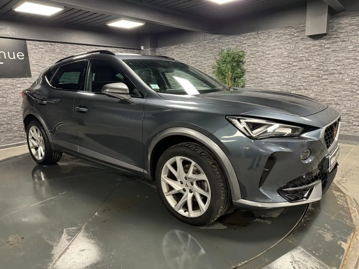Vue 3/4 avant droite du CUPRA Formentor gris magnétique avec jantes alliage 18 pouces et toit noir brillant.