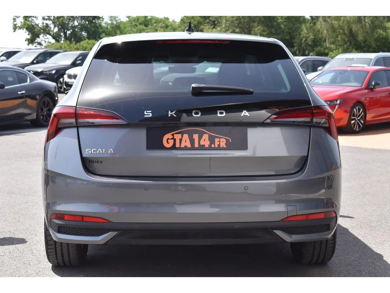 Vue arrière d'une Skoda Scala 2025 gris graphite métallisé avec feux LED et radars de stationnement visibles.
