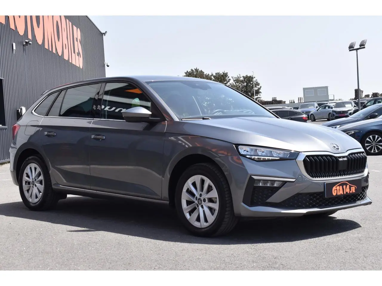 SKODA SCALA 2025 gris graphite métallisé vue 3/4 avant avec jantes alliage argent et calandre noire.