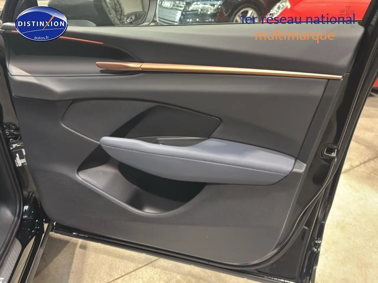 Vue rapprochée de la porte avant gauche noire du CUPRA TERRAMAR 2025 avec accoudoir gris et bandeau décoratif cuivre.