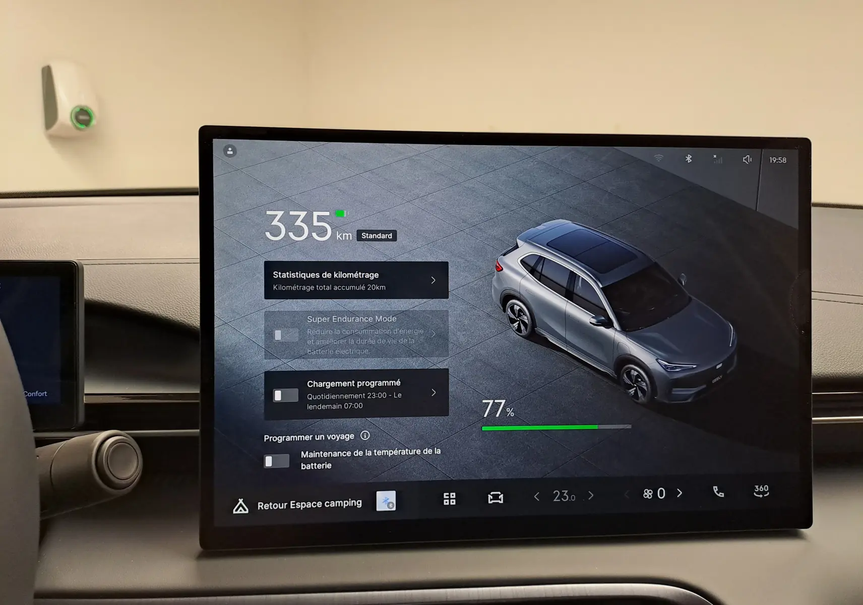 Écran central montrant une vue 3/4 arrière d'un Geely E5 PRO gris Moonlight avec autonomie et options de charge.