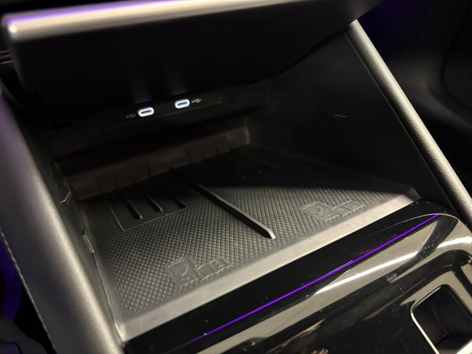 Gros plan sur la zone de recharge sans fil et ports USB dans l'habitacle du Volkswagen Tiguan 2024.