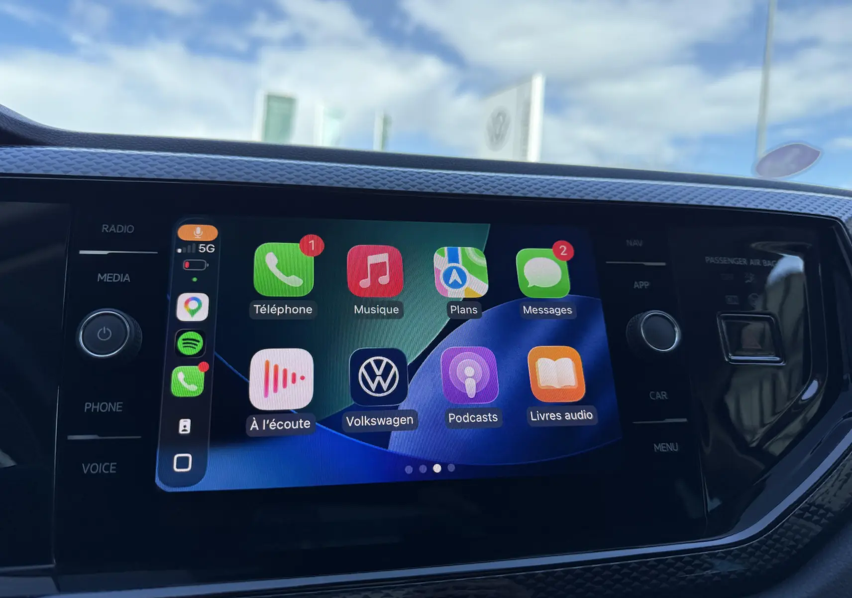 Écran tactile central du système infotainment Volkswagen avec interface Apple CarPlay active, intérieur noir.